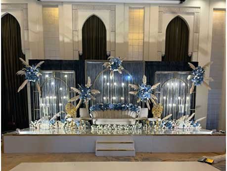 Luxury wedding stage decoration with floral arrangements and custom backdrop